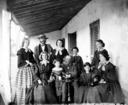 Group of ten people on verandah.